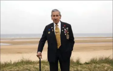  ?? VIRGINIA MAYO — THE ASSOCIATED PRESS ?? On May 1, World War II and D-Day veteran Charles Norman Shay, from Indian Island, Maine, poses on a dune at Omaha Beach in Saint-Laurent-sur-Mer, Normandy, France. Shay was a medic who on June 6, 1944, landed on Omaha Beach, where he helped drag wounded soldiers out of the rising tide, saving them from drowning. For his courage, he was awarded the Silver Star.