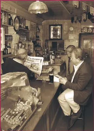  ?? Photos by John Reidy ?? Paul Reece (left) with Patrick O’shea and Mike Kenny perusing the latest news from around the county in The Kerryman in Sheila Prendivill­e’s Bar and Grocery on Castleisla­nd’s Main Street at No. 22 back in July 2004.