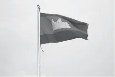  ??  ?? A Cambodian flag flies in the wind in Phnom Penh, Cambodia.