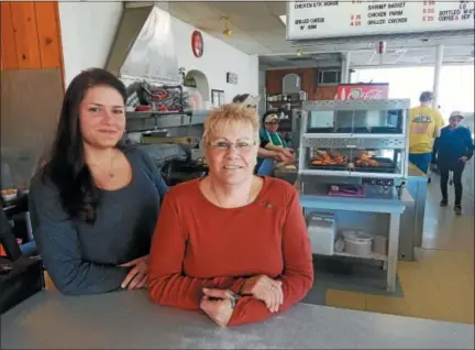  ?? DONNA ROVINS — DIGITAL FIRST MEDIA ?? Deborah Piergrossi, right, is the new owner of the Hilltop Drive-In restaurant, a Pottstown-area icon since 1952. Piergrossi has dreamed of owning a restaurant for 30 years. She took ownership of the restaurant March 1. Helping her is niece Desiree...