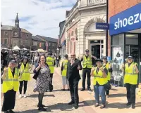  ??  ?? Cllr Terence Aldridge meets the town’s Ambassador­s at work on market day