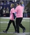  ?? CHARLES KRUPA, THE ASSOCIATED PRESS ?? Galynn Brady and Tom Brady Sr. walk on the field to recognize breast cancer awareness month Sunday in Foxborough, Mass.