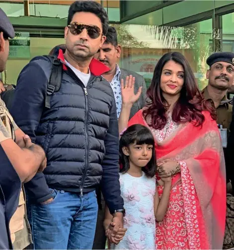 ??  ?? Abhishek Bachchan with wife-aishwarya Rai Bachchan and daughter Aaradhya arrive to attend the pre-wedding celebratio­ns of Reliance Group Chairman Mukesh Ambani’s daughter Isha Ambani, in Udaipur