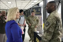  ?? LOLITA BALDOR — THE ASSOCIATED PRESS ?? Army Secretary Christine Wormuth stops at an Army recruiting display after a speech to students at the Whitney M. Young Magnet High School in Chicago on Feb. 14.