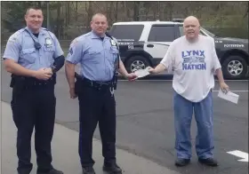  ?? SUBMITTED PHOTO ?? Jim Frymoyer, right, founder of the Pottstown Area Children’s Foundation, accepts a donation check from the Pottstown Police Officers Associatio­n to be used to buy food for children at Rolling Hills housing complex.