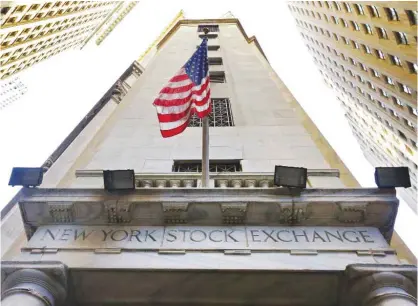  ??  ?? NEW YORK: In this Friday, Nov 13, 2015, file photo, the American flag flies above the Wall Street entrance to the New York Stock Exchange. — AP