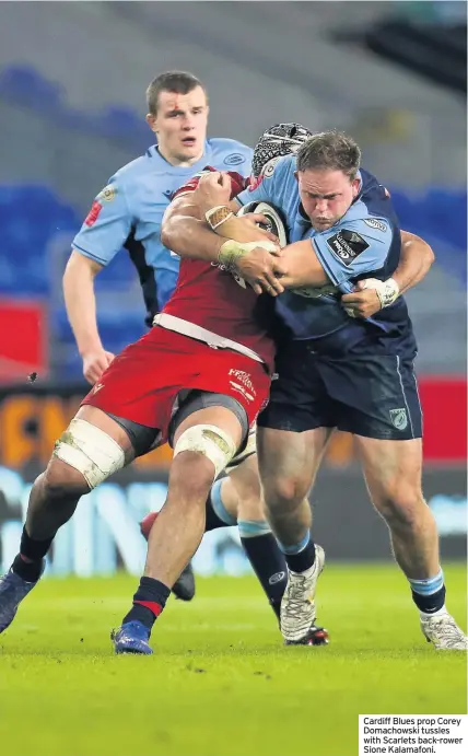  ??  ?? Cardiff Blues prop Corey Domachowsk­i tussles with Scarlets back-rower Sione Kalamafoni.