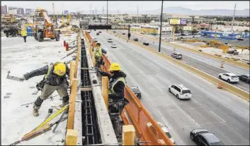  ?? Benjamin Hager Las Vegas Review-Journal file ?? Constructi­on crews work on the HOV ramp for the Spaghetti Bowl on Dec. 5.