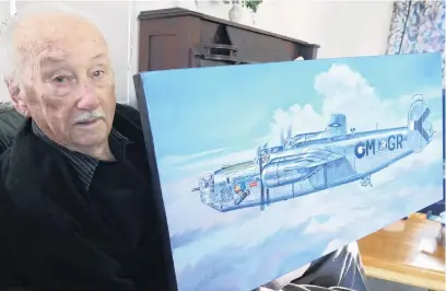  ?? PHOTO: TRACEY ROXBURGH ?? Living legend . . . Centenaria­n Ray Dunn, of Kaitaia, in Queenstown this week with his most prized possession: a painting of the Liberator bomber he flew over the Pacific, which he will give to the local Returned and Services’ Associatio­n today.