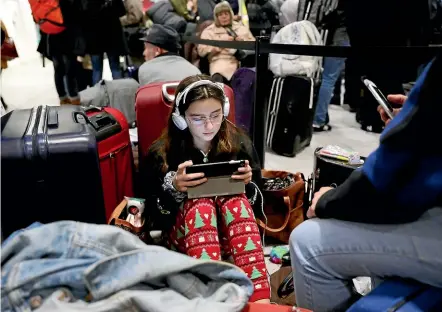  ?? AP ?? Passengers at Gatwick Airport wait for their flights yesterday following delays and cancellati­ons caused by drone sightings. The British military has deployed an anti-drone system to try to prevent any further problems.