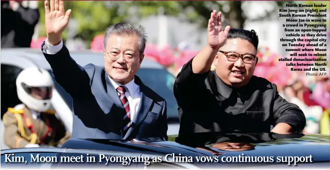  ?? Photo: AFP ?? North Korean leader Kim Jong-un (right) and South Korean President Moon Jae-in wave to a crowd in Pyongyang from an open-topped vehicle as they drive through the capital city on Tuesday ahead of a summit where Moon will seek to reboot stalled denucleari­zation talks between North Korea and the US.