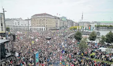  ??  ?? CALLING FOR CHANGE: Thousands of climate protesters crowd Jungfernst­ieg in the centre of Hamburg, Germany, during the ‘Fridays for Future’ demonstrat­ion on Friday.
