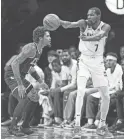  ?? VINCENT CARCHIETTA/USA TODAY ?? Then-Nets forward Kevin Durant (7) passes while defended by Hornets guard Kelly Oubre Jr. last Dec. 7.