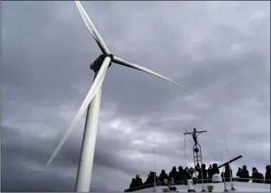  ?? (File Photo/AP/David Goldman) ?? Guests tour one of the turbines of America’s first offshore wind farm, owned by the Danish company, Orsted, off the coast of Block Island, R.I., as part of a wind power conference, in October.