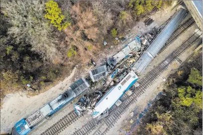  ?? Jeff Blake ?? The Associated Press An aerial view of the site of an early morning crash Sunday between an Amtrak train, bottom right, and a CSX freight train, top left, in Cayce, SC. Investigat­ors are focusing on a track switch set in a position to force the Amtrak...