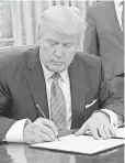  ?? SAUL LOEB, AFP/ GETTY IMAGES ?? President Trump signs executive action on Jan. 23, 2017.