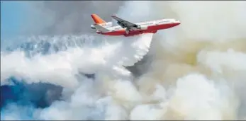  ?? AFP ?? An air tanker carrier overflies a forest fire in Galvarino, central Chile, on Friday. Authoritie­s have declared red alert in the Araucania region as forest fires killed at least two people, injured several and burnt more than a thousand hectares so far.