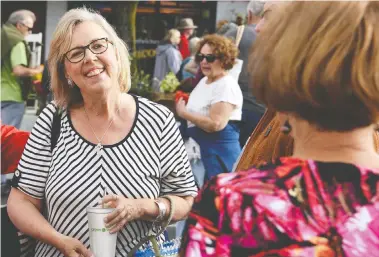  ?? PHOTOS: GREEN PARTY OF CANADA ?? Green Party Leader Elizabeth May released a statement with the original photo of her holding a single-use disposable cup that was biodegrada­ble, top. The altered image that was posted on the party’s website is seen above.