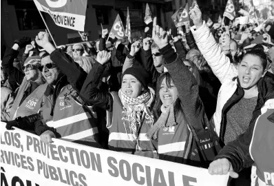  ?? AP ?? CGT Union protesters cheer at a march during a mass strike in Marseille, southern France, Tuesday, December 10, 2019.