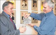  ?? P.E.I. GOVERNMENT PHOTO ?? Dean Stewart, chair of the Environmen­tal Advisory Council, right, pours Communitie­s, Lands and Environmen­t Minister Robert Mitchell a glass of water following the tabling of the Water Act in the P.E.I. Legislatur­e.