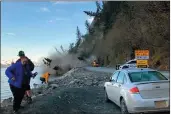  ?? JOSH GRAY VIA AP ?? People run from a landslide just outside the downtown area of Seward, Alaska.