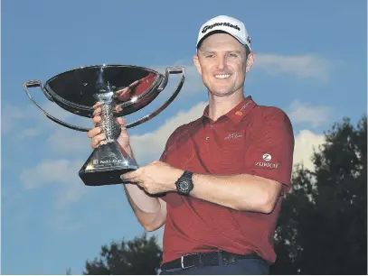  ?? Picture: AFP ?? IN THE MONEY. FedEx Cup champion Justin Rose of England poses with the trophy after the final round of the Tour Championsh­ip at East Lake Golf Club in Atlanta on Sunday.