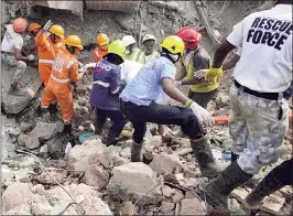  ??  ?? Rescue operation at the spot where a building collapsed in Mahad on Tuesday