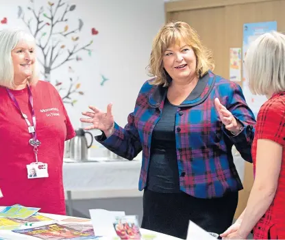  ?? Picture: Lesley Martin. ?? Culture Secretary Fiona Hyslop, centre, announced the funding during a visit to Dunfermlin­e Carnegie Library and Galleries.