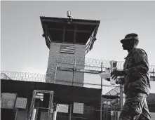  ?? Ramon Espinosa / Associated Press ?? A U.S. soldier walks past the Camp VI detention facility at the U.S. Guantanamo Bay naval base in Cuba.