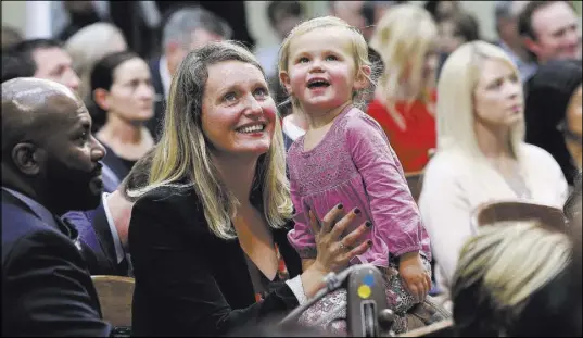  ?? Rich Pedroncell­i The Associated Press file ?? In this Dec. 3 photo, freshman Assemblywo­man Buffy Wicks and her daughter, Josephine, 2, look at the Assembly Gallery during the Legislativ­e session in Sacramento, Calif.