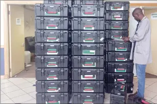  ?? (File pics) ?? The equipment that will be used for the national elections, being inspected before it was loaded to be delivered to different registrati­on stations, to be used by the registrati­on clerks.