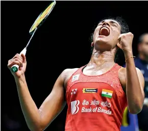  ?? AFP, AP ?? LEFT: P. V. Sindhu celebrates her victory over Nozomi Okuhara in the women’s singles quarterfin­als. RIGHT: Saina Nehwal reacts during her 6-21, 11-21 defeat to Carolina Marin on Friday.
