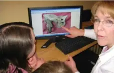  ??  ?? Susan Moorhead Mooney, an osteologis­t who worked on the Dawson City mystery, shows students images from the project.