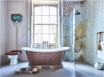  ??  ?? Catchpole & Rye designs, including a copper bath, give this bathroom a distinctiv­e mood