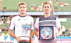  ??  ?? Pablo Carreno Busta of Spain (left) holds the trophy after defeating Matthew Ebden of Australia (right) in the final of the Kooyong Classic tennis tournament in Melbourne on January 12, 2018. - AFP photo