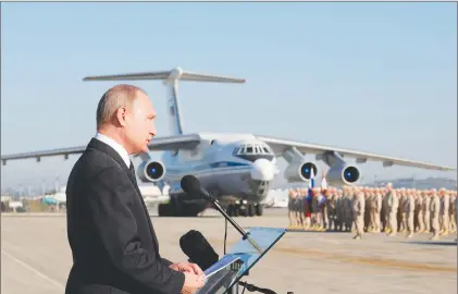  ?? AP PHOTO ?? In this file photo taken on Tuesday, Dec. 12, 2017, Russian President Vladimir Putin addresses the troops at the Hemeimeem air base in Syria. Several private Russian military contractor­s were killed by a U.S. strike in Syria, Russian media reported...