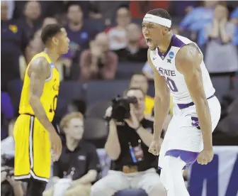  ?? Ap pHoto ?? WILDCATS STRIKE: Kansas State’s Xavier Sneed (20) celebrates after a dunk against UMBC during the second half of a second-round game in the NCAA men’s college basketball tournament in Charlotte, N.C.