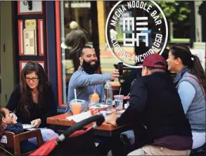  ?? Erik Trautmann / Hearst Connecticu­t Media ?? Local patrons dine at Mecha Noodle Bar on Washington Street in Norwalk last May.