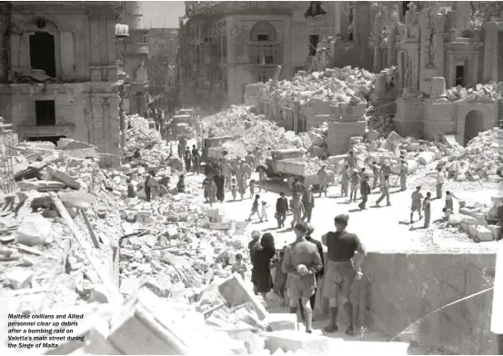  ??  ?? maltese civilians and allied personnel clear up debris after a bombing raid on Valetta’s main street during the Siege of malta