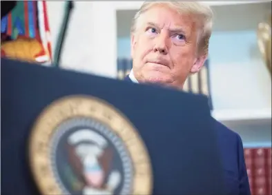  ?? Saul Loeb / AFP / Tribune News Service ?? President Donald Trump looks on during a ceremony presenting the Presidenti­al Medal of Freedom to wrestler Dan Gable in the Oval Office of the White House on Monday in Washington.