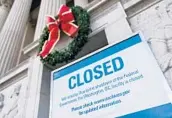  ?? ANDREW CABALLERO-REYNOLDS/GETTY-AFP ?? A sign is displayed Saturday at the National Archives, which is closed because of a government shutdown.