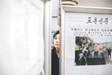  ??  ?? A woman reads newspapers displayed at a subway station visited by foreign reporters, in central Pyongyang, North Korea April 14. China’s imports from North Korea surged nearly 20 per cent in the first quarter despite internatio­nal sanctions and a...