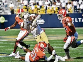  ?? HYOSUB SHIN/HYOSUB.SHIN@AJC.COM ?? Tech running back Bruce Jordan-Swilling is tackled by Clemson’s Malcolm Greene (21) on Saturday. Tech’s offense was held to a season-low 204 yards.