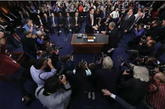  ?? ANDREW HARNIK — THE ASSOCIATED PRESS ?? Former FBI director James Comey is greeted by Senate Intelligen­ce Committee Chairman Richard Burr, R-N.C. at the beginning of the Senate Intelligen­ce Committee hearing on Capitol Hill, Thursday in Washington.