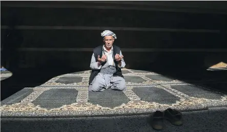  ?? SAFIN HAMEDSAFIN HAMED/AFP- GETTY IMAGES ?? An Iraqi Kurd prays on the occasion of the Prophet Muhammad’s birthday in the town of Akra, some 500 kilometres north of Baghdad, on Thursday.