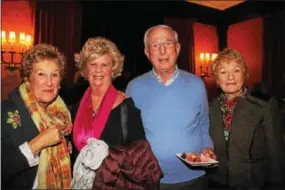  ??  ?? Wynnewood residents Nancy Gabel Broder and her spouse, George, check-out the hors díoeuvres with Caroline Cuthbert, also of Wynnewood and Bambi Dudley of Radnor.