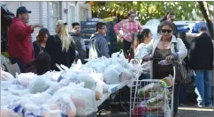  ??  ?? Community members received a variety of holiday food items at the 44th annual El Granito Foundation Food Basket Giveaway Thursday.