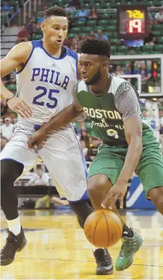  ?? AP PHOTO ?? YOUNG GUNS: Celtics top pick Jaylen Brown (right) drives to the hoop against Philadelph­ia’s Ben Simmons, the first overall selection in the draft, during the second half of last night’s summer-league opener in Salt Lake City. Brown scored 16 points as...