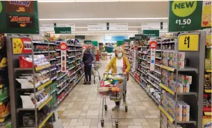  ?? (Peter Cziborra/Reuters) ?? A CUSTOMER WEARING a protective face mask shops at a Morrisons store in St Albans, north of London last year.