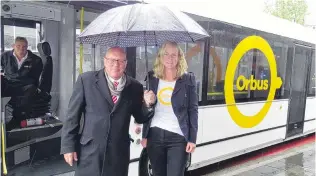  ?? PHOTO: TRACEY ROXBURGH ?? Happy birthday . . . Orbus driver Stephen Poole watches as Queenstown Lakes Mayor Jim Boult and Otago Regional Council deputy chairwoman Gretchen Robertson mark the first year of Orbus, the Wakatipu’s $2 bus network, in Queenstown yesterday .